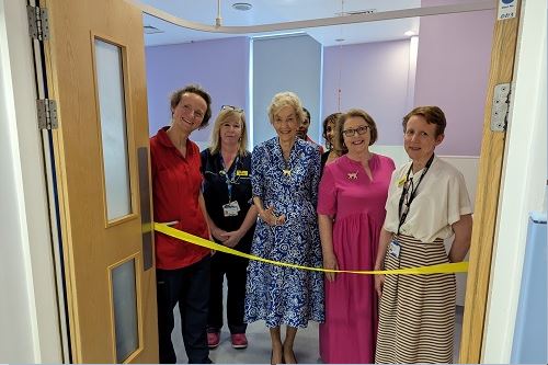 Baroness Cumberlege cuts a yellow ribbon at the entrance to one of the birth rooms